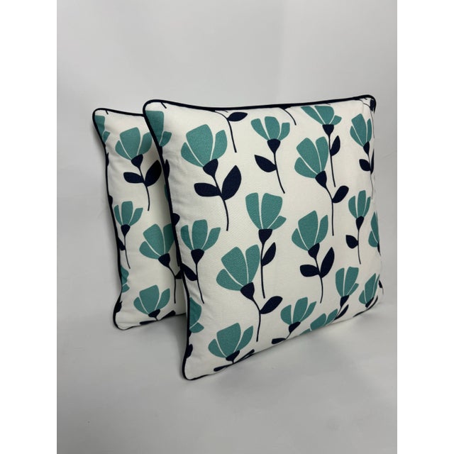 Beautiful and simple aqua floral pillows. Complete with dark blue welt, plain white woven back, hidden zipper closures,...