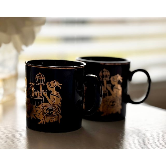 This pair of charming vintage Japanese matcha tea mugs feature a deep navy blue hue complemented by intricate gold painted...