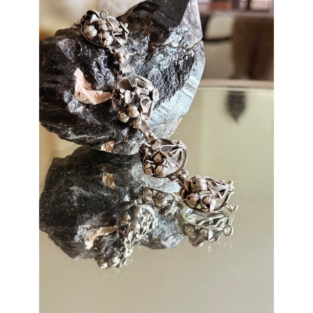 1940s sterling silver floral panel bracelet featuring dimensional botanical repoussé work and sculptural flower motifs....