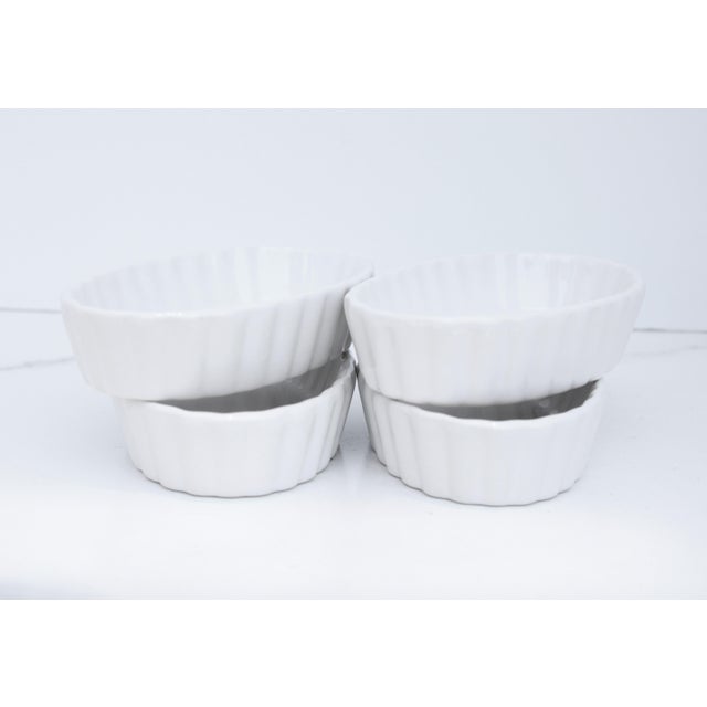 Set of four oval shaped ramekins, made of procaine. We love to use these tiny ramekins for serving dips, sauces, and...