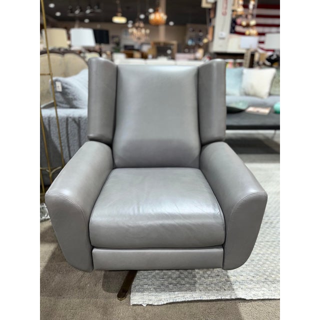The "Luke" Swivel Recliner from Restoration Hardware offers a refined fusion of comfort and modern design. Upholstered in...