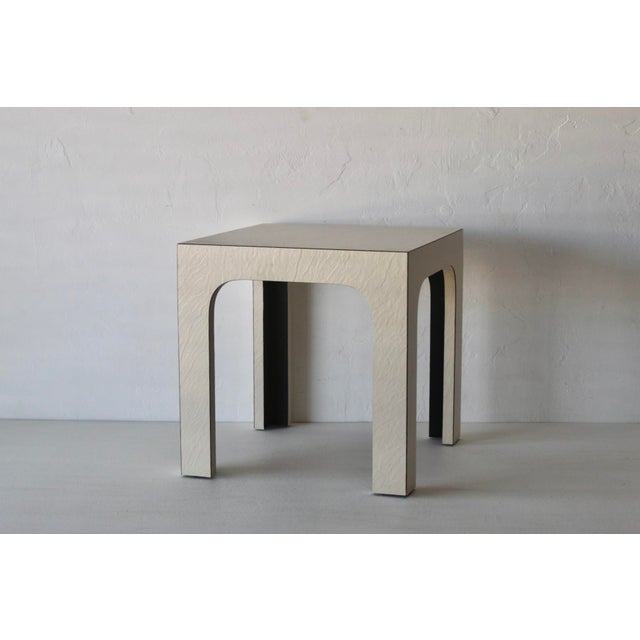 An off -white matte laminate end table with nice lines. 1980s Modern Postmodern design period. Great as an end table or...