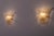 Pair of textured Murano glass sconces mounted on a solid brass base, produced by the Italian luxury lighting manufacturer...