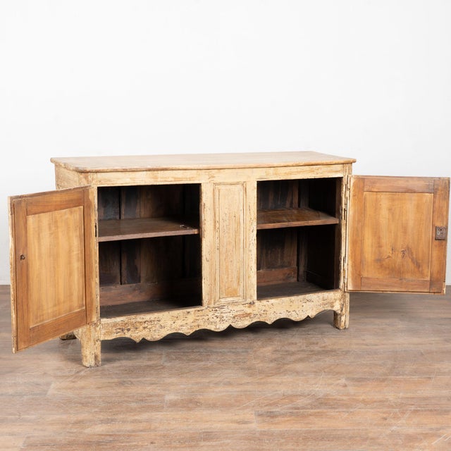 19th century French sideboard buffet, crafted in hardwood with an old painted finish. While the paint is aged, it is not...