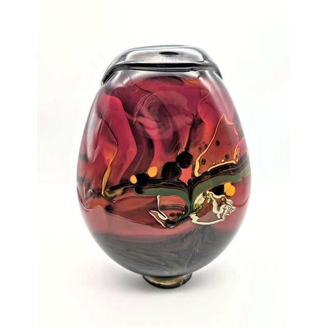 This exquisite studio glass vessel is a captivating collector's item by the renowned French glass artist Robert Pierini....