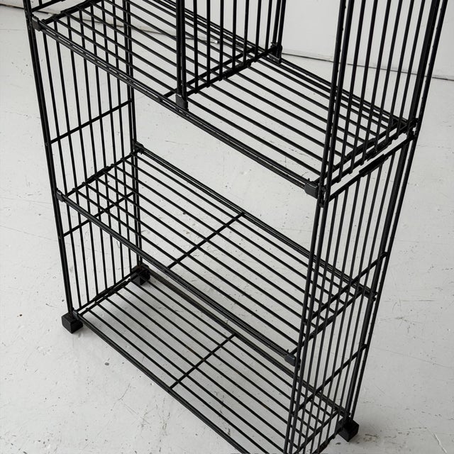 c. 1970s. Constructed of iron. Shelf heights adjustable. Made in Spain. This piece is attributed to the mentioned...