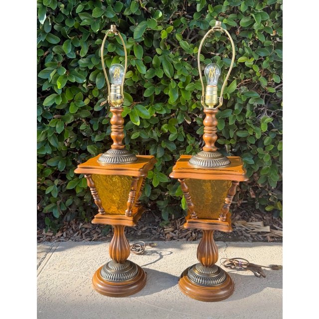 Beautiful matching pair of vintage table lamps featuring richly finished turned wood, decorative carved details, antique...