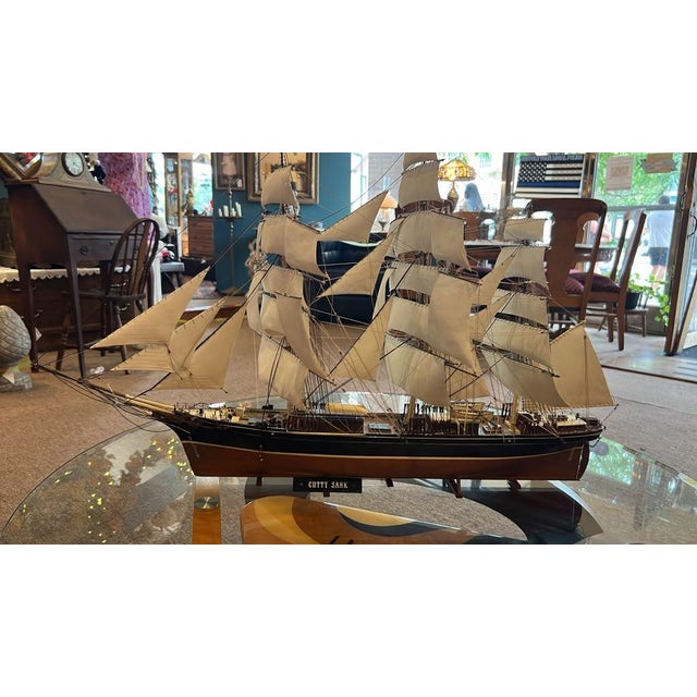 A beautifully crafted scale model of the Cutty Sark, a legendary 19th-century British clipper ship celebrated for her...