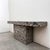 Striking vintage console table featuring a bold Postmodern silhouette and dramatic charcoal and light grey geometric...