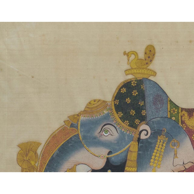 Traditional Rajasthani miniature painting of a blue royal elephant decorated with gold jewelry ornaments on his head,...
