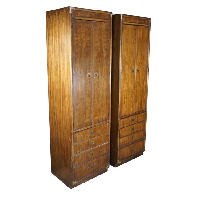 A pair of vintage Drexel Accolade II clothing armoires, cabinets, closets. Made of walnut featuring Campaign styling with...