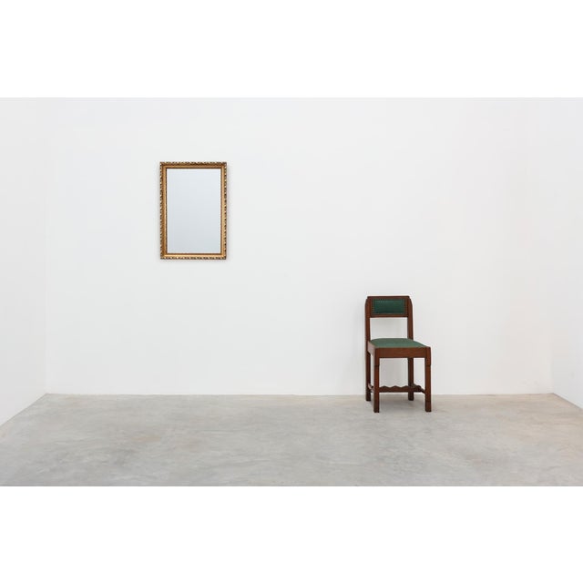 An elegant Belgian mirror from around 1900, featuring a finely molded giltwood frame in the Neoclassical style. The...