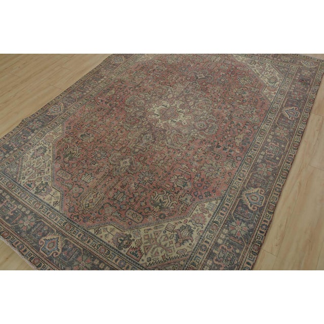 An authentic vintage traditional Tabriz rug hand-knotted with fine wool and natural dyes. This oriental rug features muted...