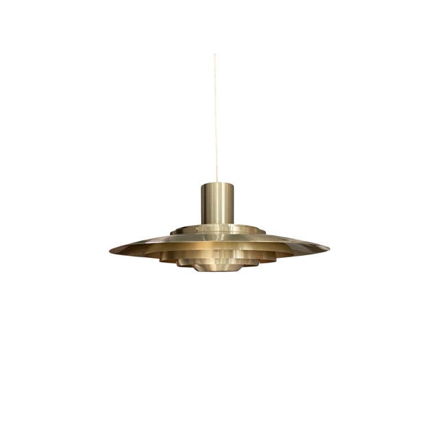 Five concentric hand-spun aluminum shades in a warm brushed brass finish give this large 28-inch 1960s Danish P376 pendant...