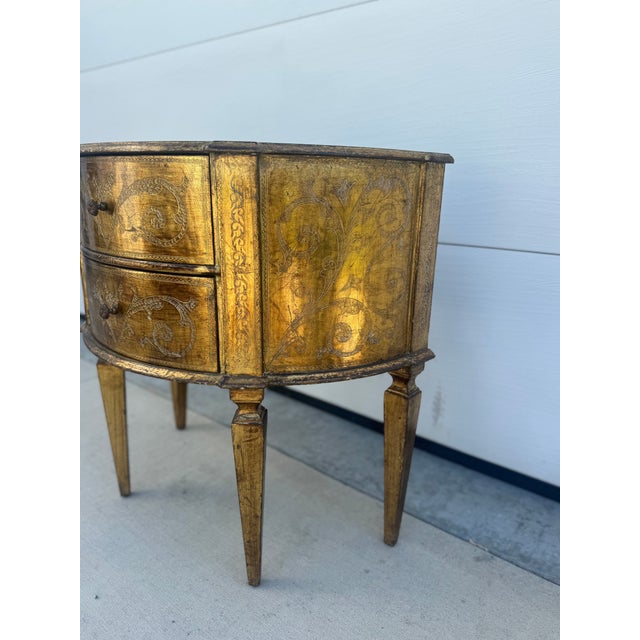 Italian Florentine demi-lune two drawer side table. Gilded, made in Italy.