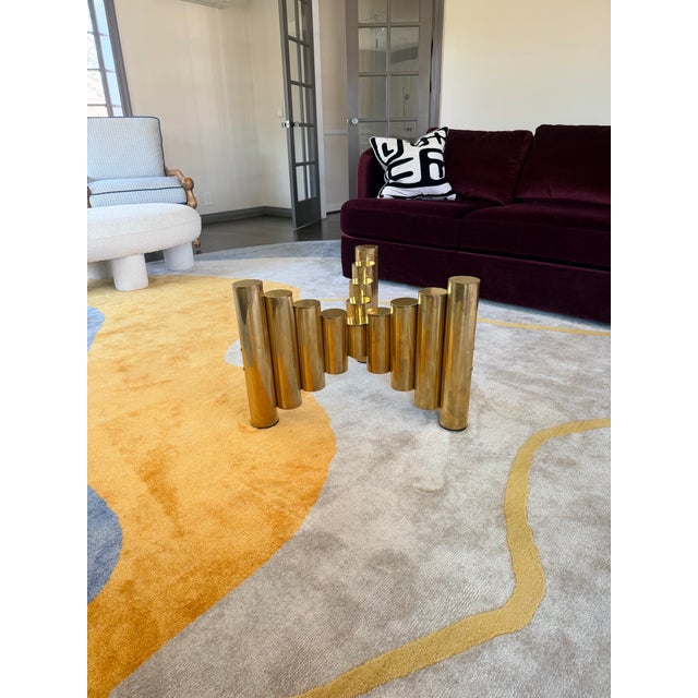 The coffee table base is a postmodern sculptural style piece with strong 1970s–1980s influences. With Brass cylindrical...