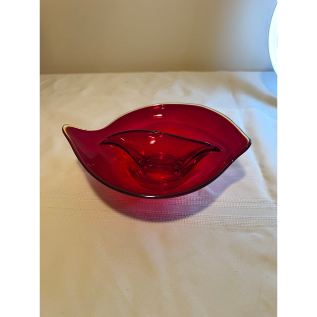 Elevate your tabletop or vanity with this striking Mid-Century Modern ruby red art glass divided dish. Crafted in a...