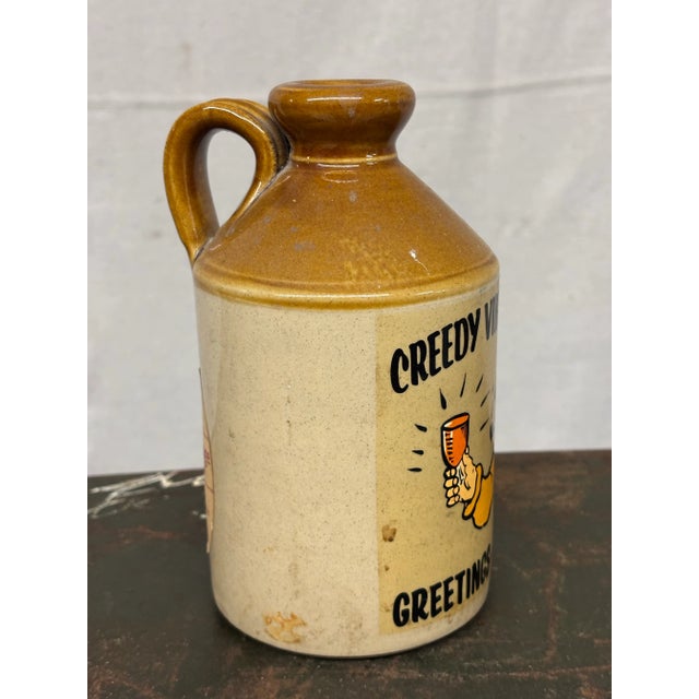 This charming vintage English cider flagon captures the spirit of Cornwall with its delightful graphic of a cheerful man...