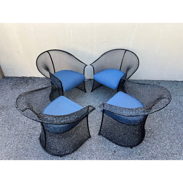 Vintage 1950s chairs attrubuted to Russel Woodard featuring a sculptural design with a drape kind of look wire mesh to the...