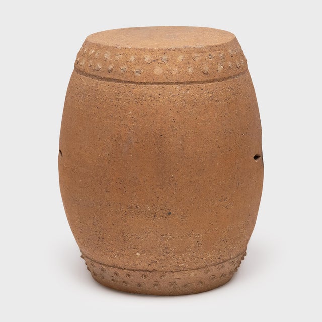 This terracotta garden stool from the early 20th century honors tradition with its simple, drum-form shape. A pattern of...