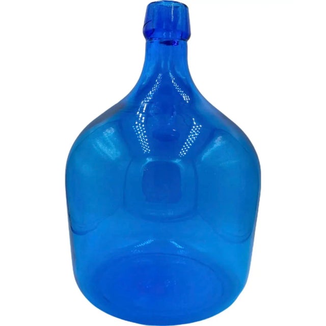 Details: -Beautiful hand-blown blue glass bottle/jug -Perfect for any home and would also make a lovely gift! -Bottle has...