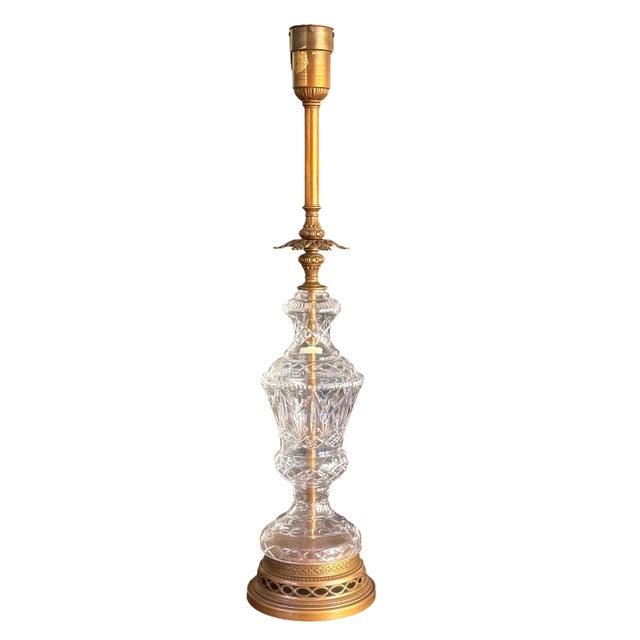 A tall neoclassical table lamp, with the base alone standing 40 inches overall, combining a turned brass column and...