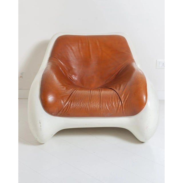 This chair features a molded polyurethane frame with a leather seat.