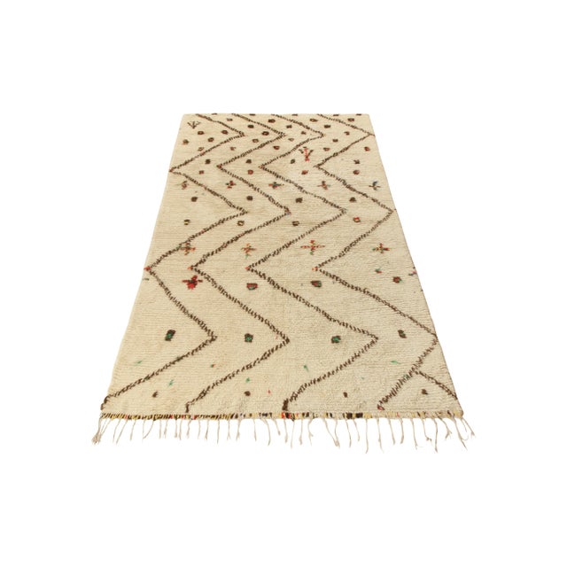 Hand knotted in wool from Morocco circa 1950-1960, a vintage 9x12 Berber style Moroccan rug of rare scale and quality. The...