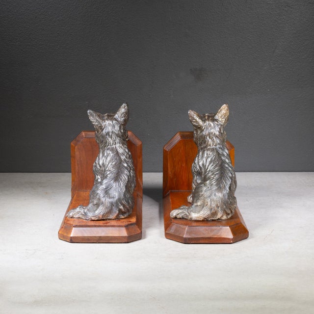 ABOUT A vintage pair of hand crafted bronze plated Scotty Dog bookends on wooden pedestals with original green felt....