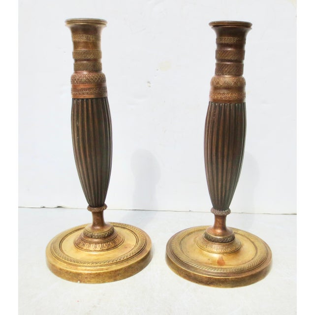 French Empire Bronze Candlesticks, c. 1830. Classic bronze single-stem candlesticks. Turned and tooled in fine detail to...