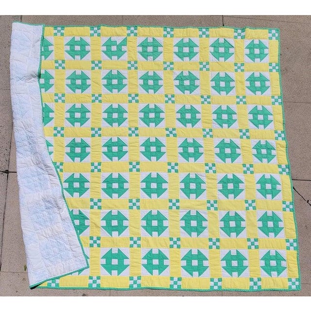 This fun hole in the barn door pattern quilt is in butter cup yellow and mint green colors.The condition is very good and...