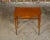 A French folding table from the 19th century with burlwood accents, inlaid rim, elongated diamond motif and tapered legs....