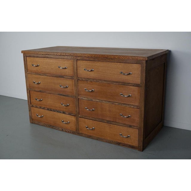 This cabinet was produced in the early 20th century in France. It features 8 large drawers with nice ornate handles. It...