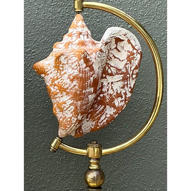 This elegant pair of vintage table lamps combines warm brass, natural wood, and striking shell elements in a design that...