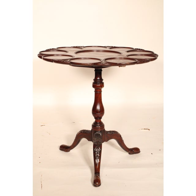 Antique George II style mahogany supper table, 19th century. The top with 9 outer circular recessed areas for plates...