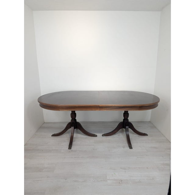 Antique mahogany table in the Regency style with brass lion paws. The table is covered with high-quality mahogany veneer,...