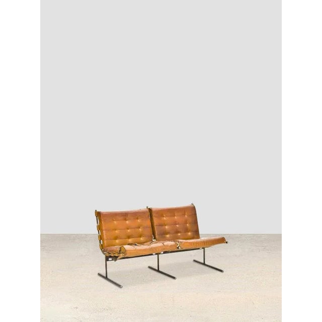By jorge zalzsupin, 1960’s oxford armchair with chrome-plated metal frame and brown leather-covered seats and backrests....
