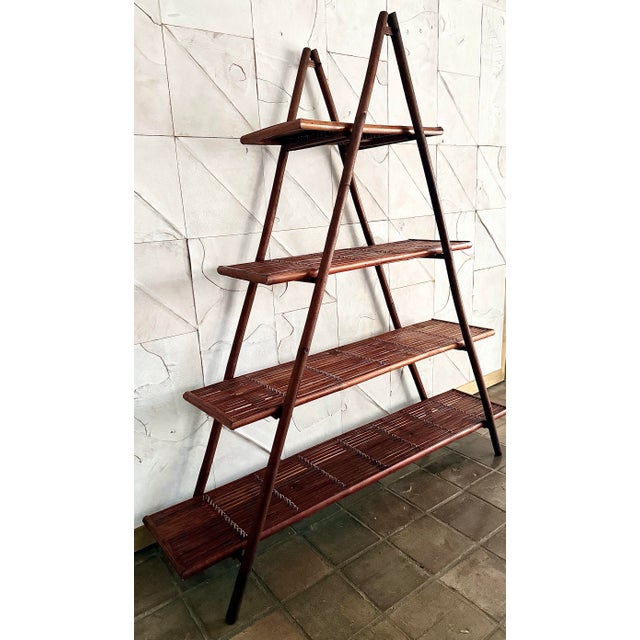This rare dark-stained bamboo, rattan 4-tier A-frame cascade display étagère features slatted graduated shelves and...