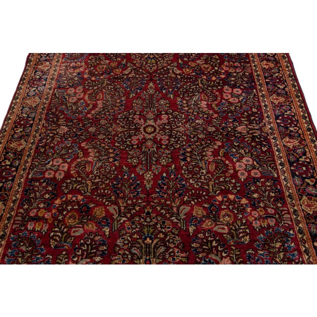 Beautiful Antique Sarouk Farahan hand-knotted wool rug with a red field. This sarouk rug has multi-color accents on a...