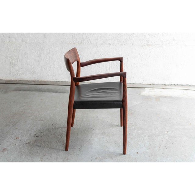Side chair ‘model 56’ designed by Niels Otto Moller and produced by J.L. Moller in Denmark during the 1960’s. This captain...