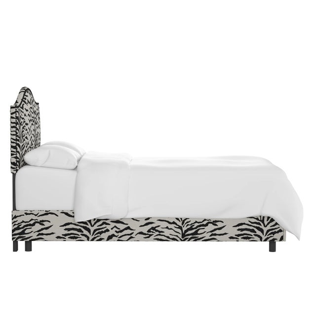 Give your interior a lift with the Bed. Featuring the delicate curves of a classic camelback design, with subtle nailhead...