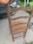 For sale is a charming Early American primitive-style wooden ladderback side chair. This standalone piece features a...