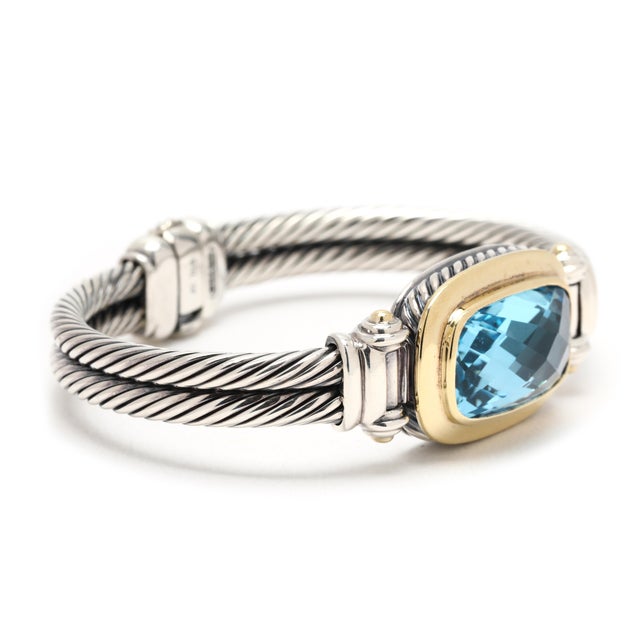 Stones: blue topaz, 1 checkerboard elongated cushion 22 x 12 mm Circumference: 6.25 inch Width: 7.6 mm (cable) Weight:...