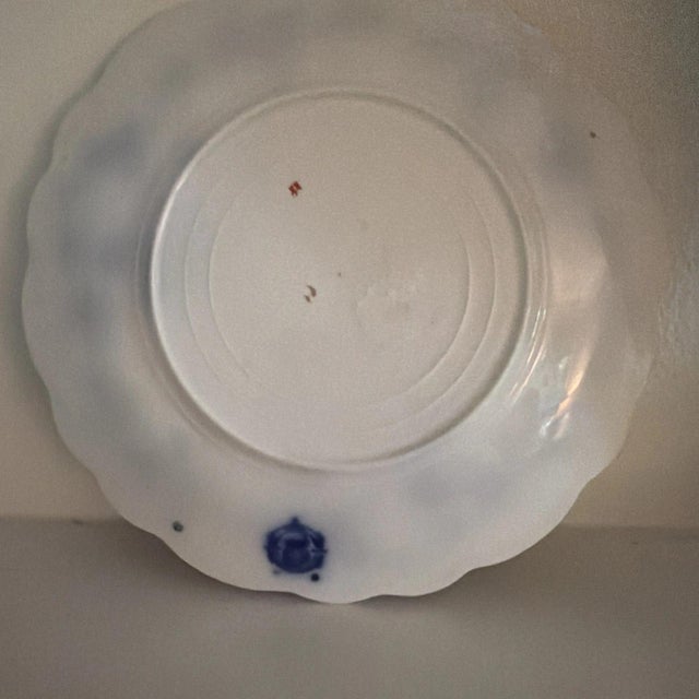 W. H. Grindley Antique Flow Blue Plate Dating From 1880s. The 9" plate has a floral pattern with gold trim on the edge.
