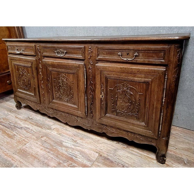 Important louis xv period sideboard in solid carved oak, circa 1750 the front opens with three doors and three drawers...