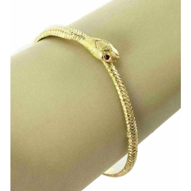 The Ruby Textured Snake Bypass 18k Yellow Gold Bangle Bracelet is a stunning piece of vintage jewelry that exudes elegance...