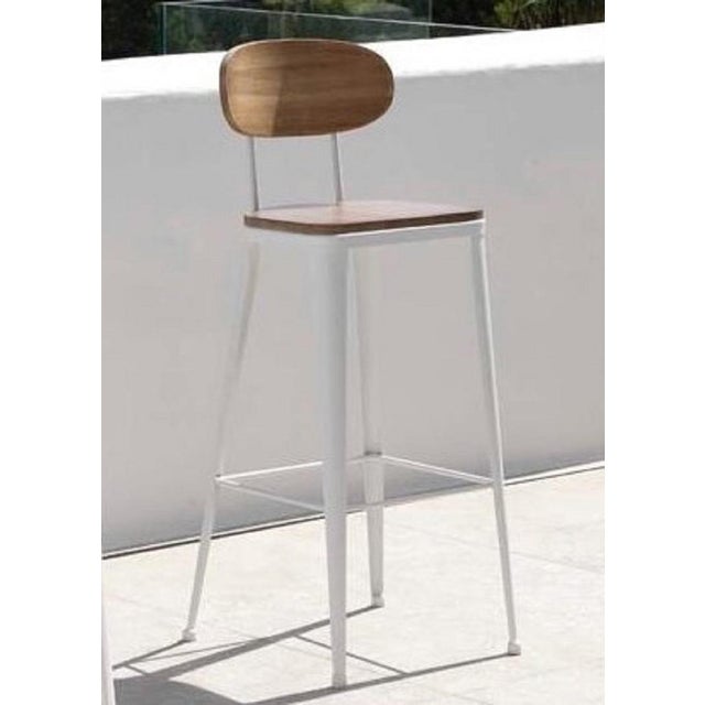 Industrial, counter height, shop stool features a wrought iron frame and seat.