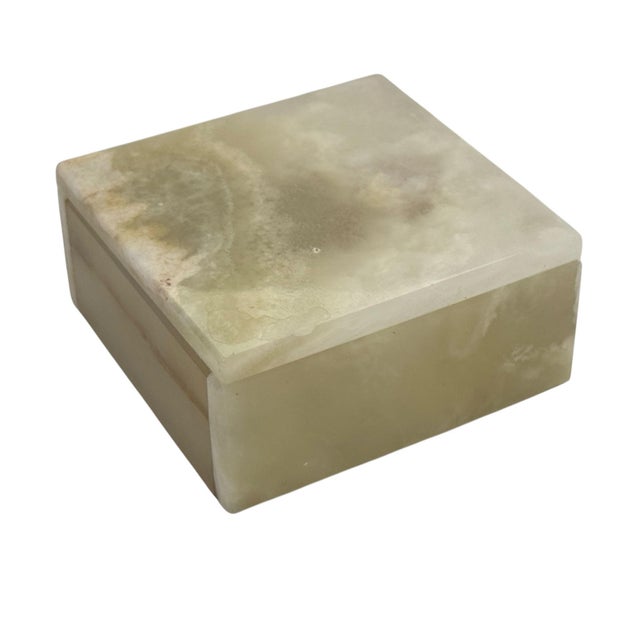 This elegant box is carved from pale green onyx, beautifully accented with natural brown and white inclusions that give it...
