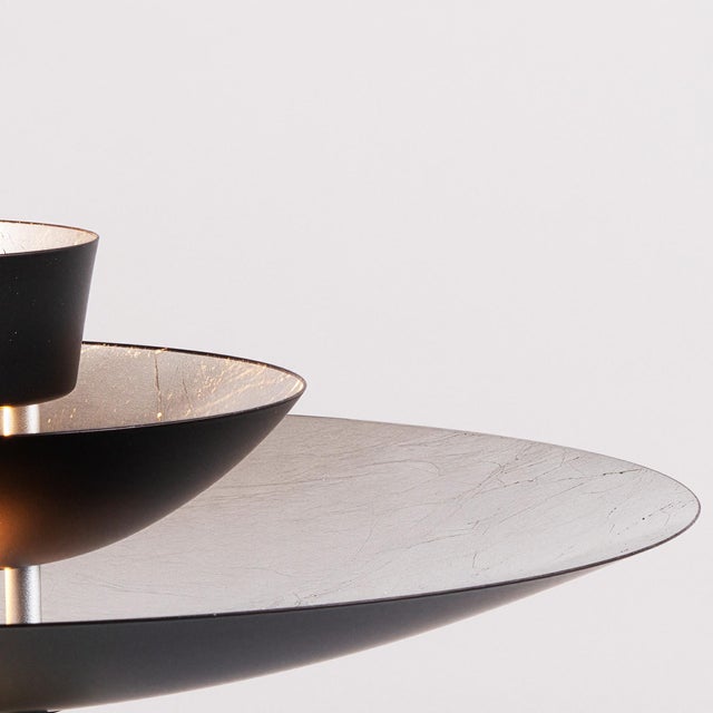 Constructed with a Matte Black/Silver steel shade and a Satin Nickel steel body, the Fleur Torchiere is a modern lighting...