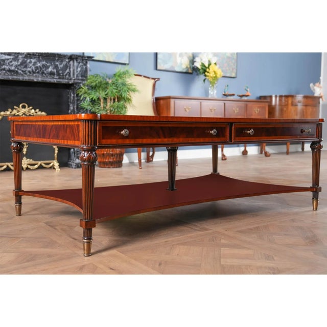 A Large Coffee Table from Niagara Furniture with all of the bells and whistles including four drawers, reeded legs, solid...